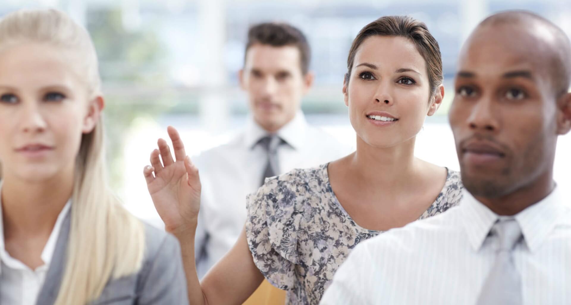 eager woman raising hand in crowd