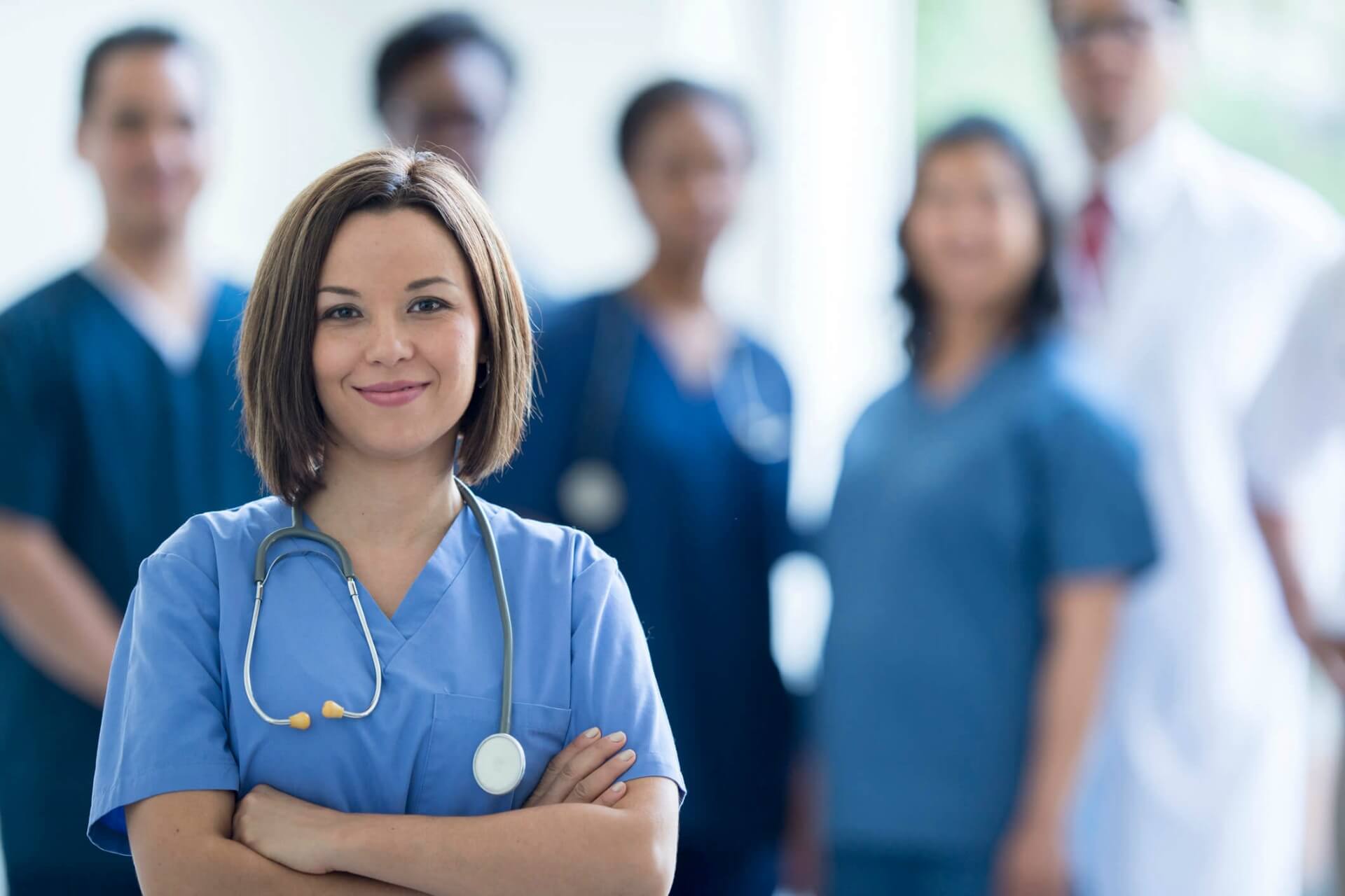 young female doctor in front of group of doctors