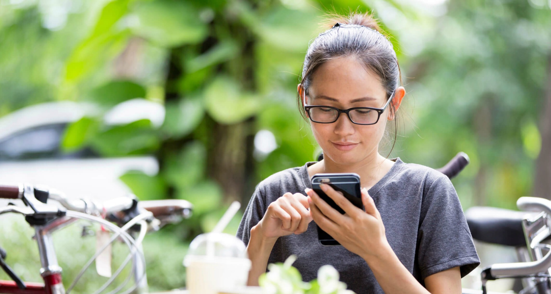 Young woman sitting outside using her cellphone