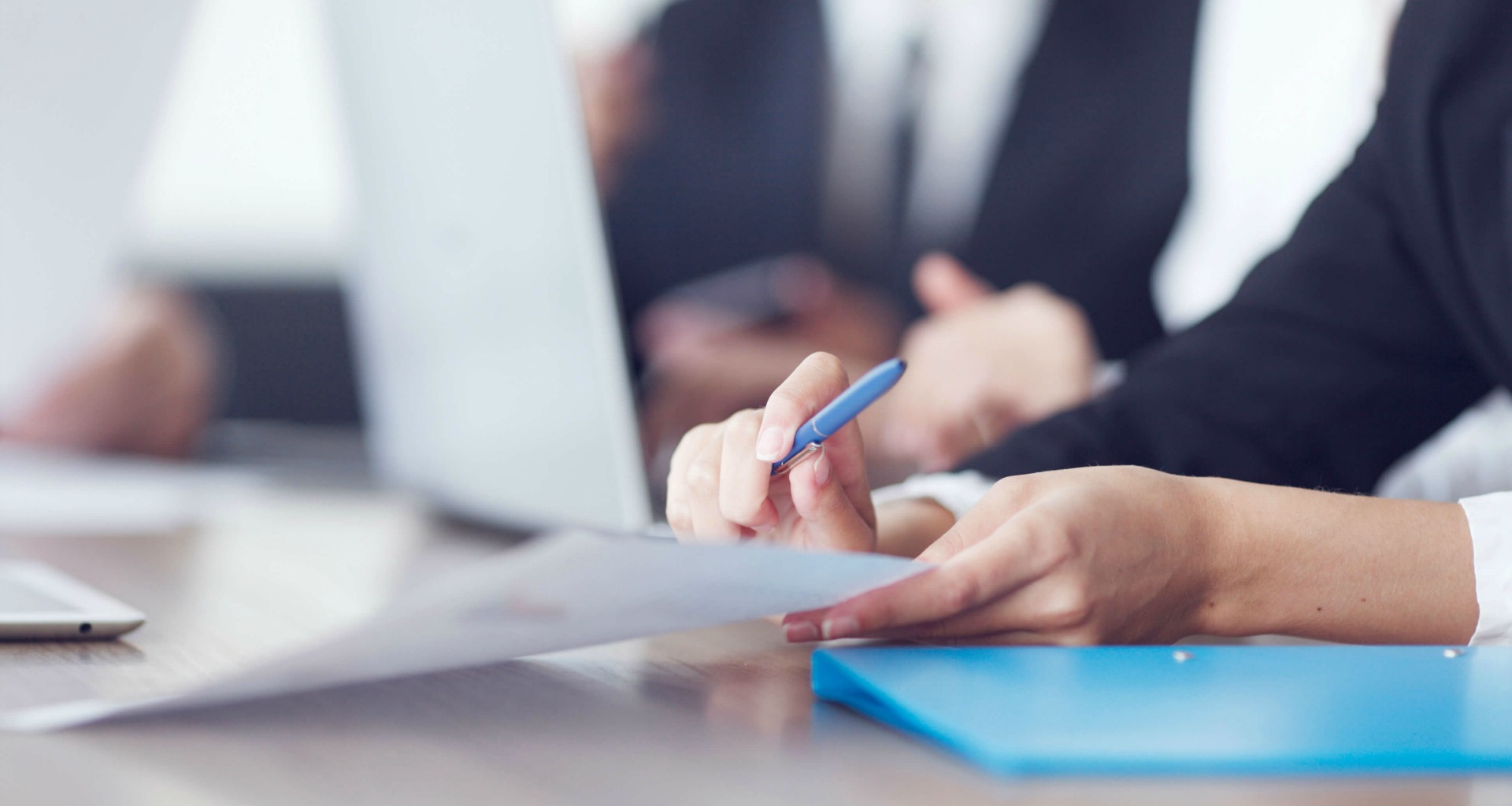 person holding paperwork and a pen