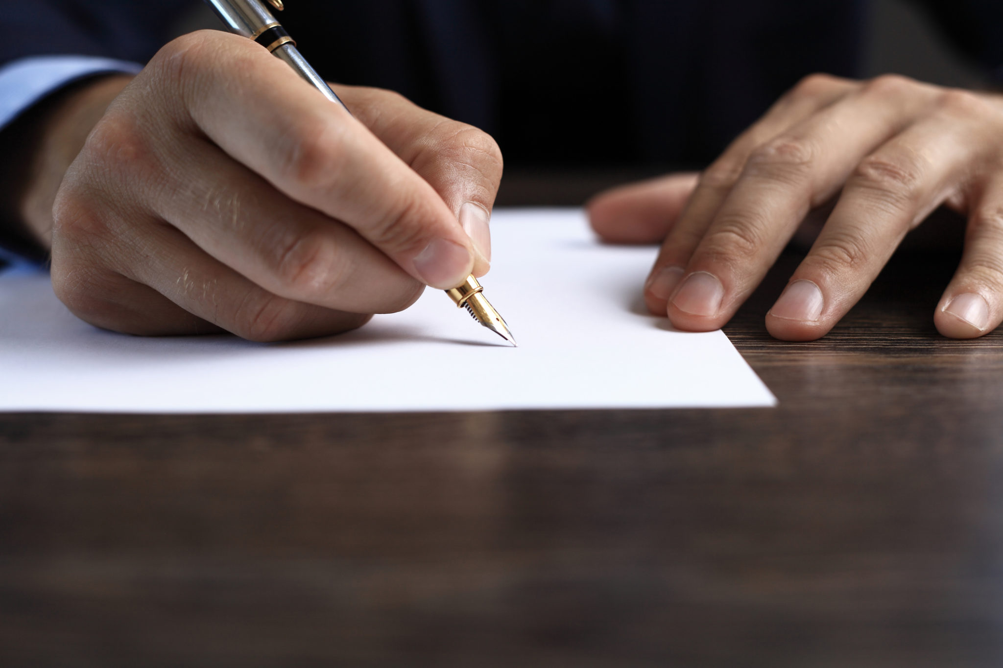 person writing with an old pen